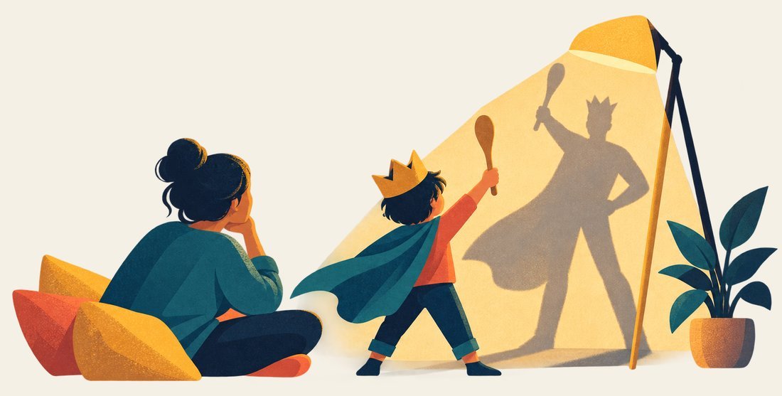 A child in a paper crown casts the shadow of a grown-up hero